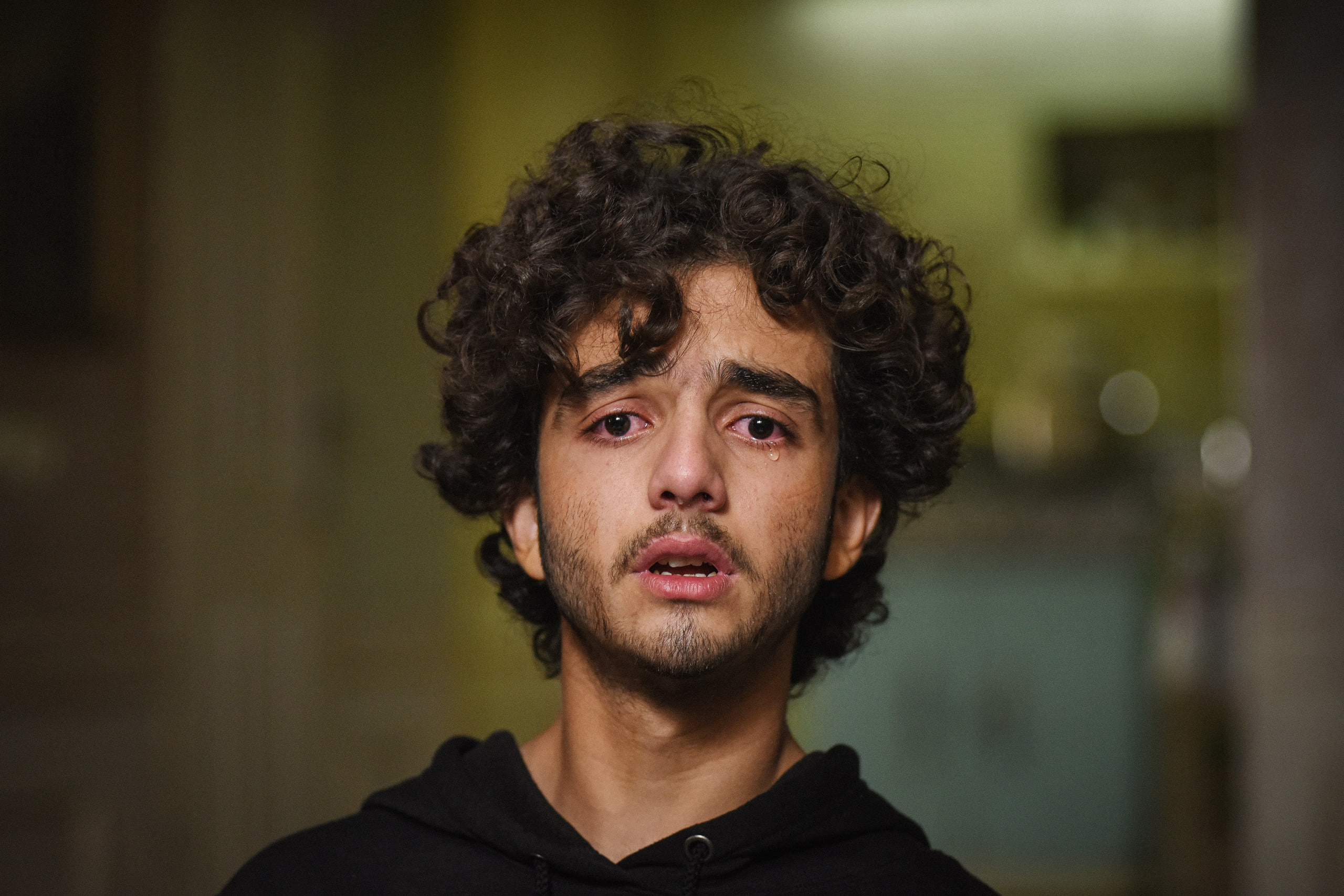 Emotional portrait of a young man crying
