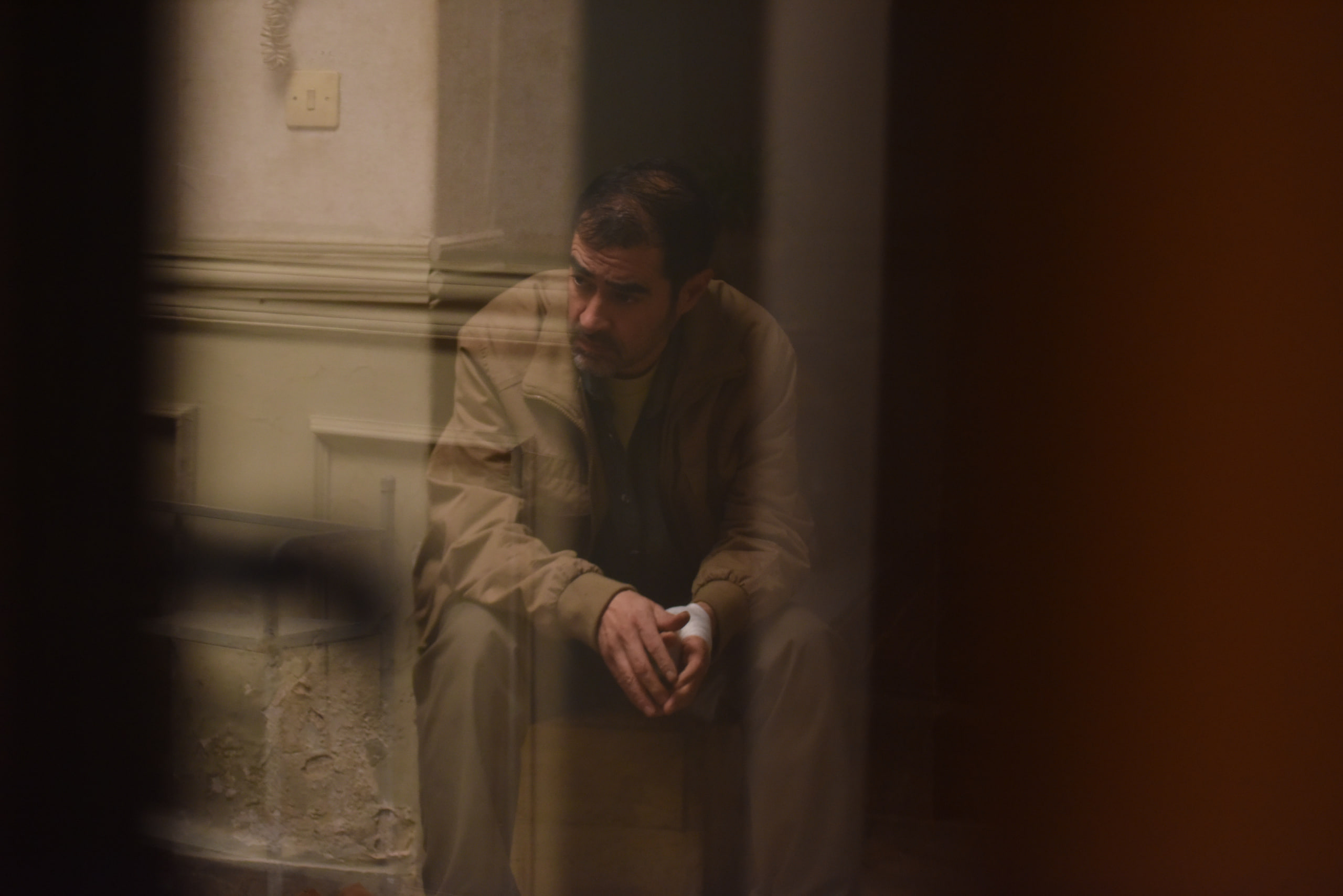 Shahab Hosseini reflection behind glass