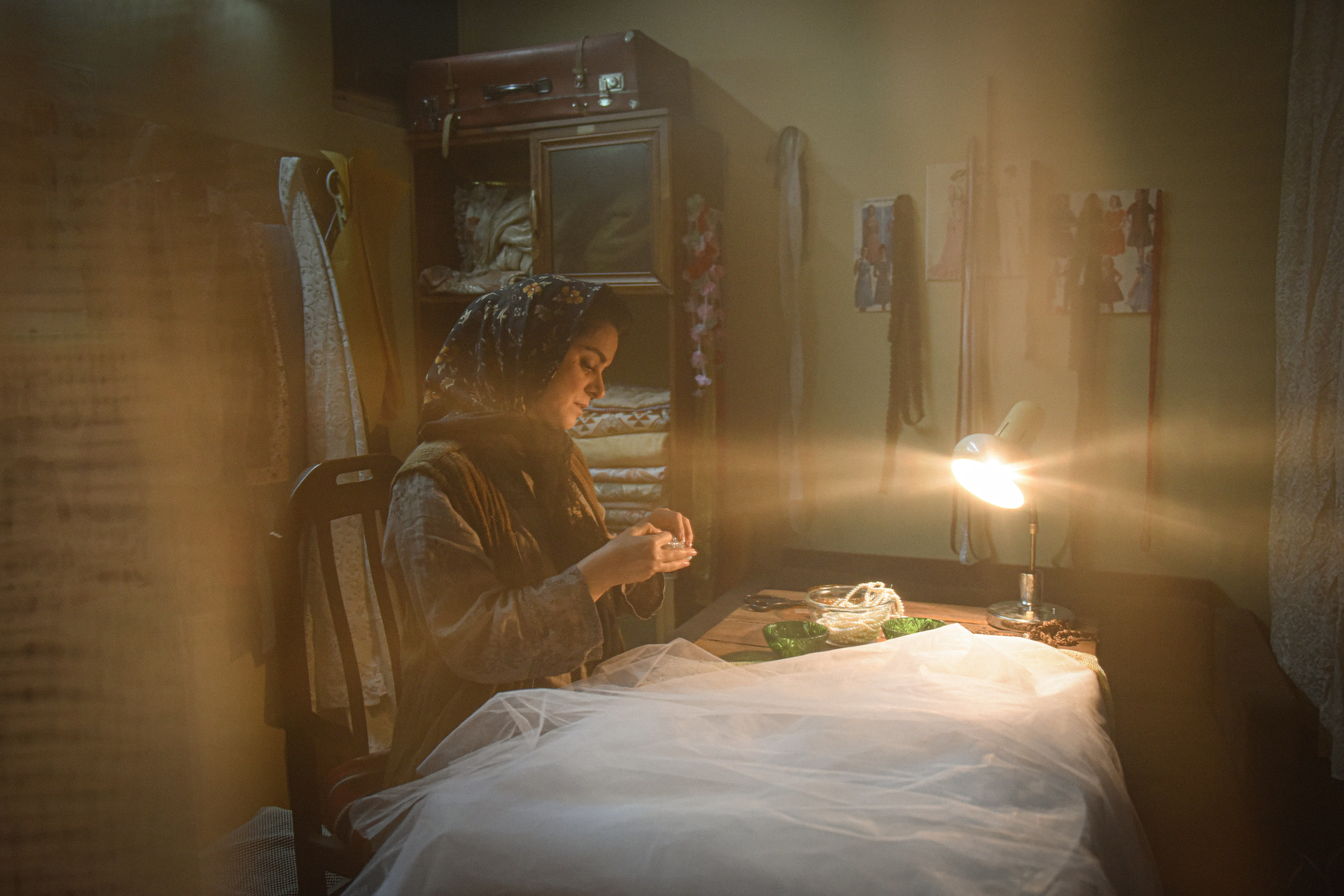 Ghazal Shakeri sewing a white dress